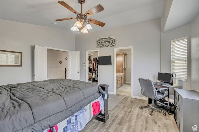 11645 S Keystone Dr, South Jordan, UT 84009 - bedroom with lofted ceiling, light wood-style floors, a walk in closet, a desk, and a closet