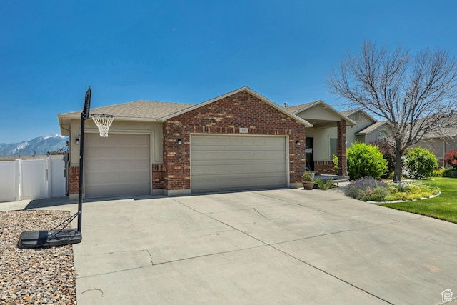 11645 S Keystone Dr, South Jordan, UT 84009 - ranch-style home with an attached garage, brick siding, driveway, and a mountain view