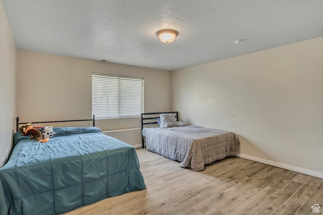 11645 S Keystone Dr, South Jordan, UT 84009 - bedroom featuring light wood finished floors and baseboards