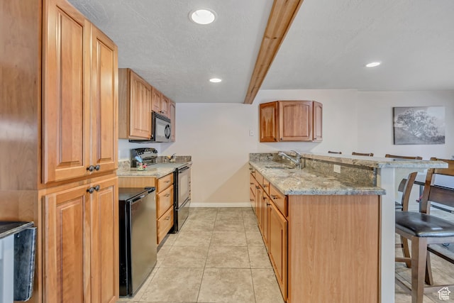 11645 S Keystone Dr, South Jordan, UT 84009 - kitchen featuring black appliances, a breakfast bar area, a peninsula, light stone counters, and recessed lighting
