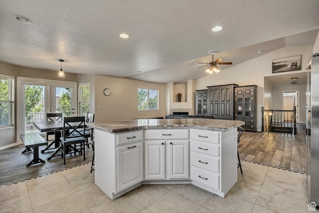 11645 S Keystone Dr, South Jordan, UT 84009 - kitchen with a kitchen island, a ceiling fan, white cabinetry, recessed lighting, and lofted ceiling