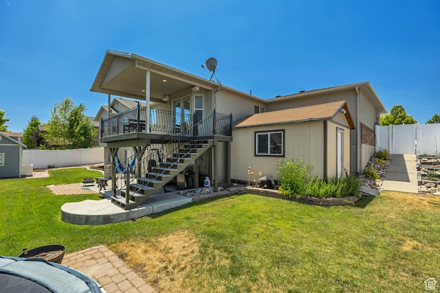 11645 S Keystone Dr, South Jordan, UT 84009 - rear view of house with stairs, a fenced backyard, a patio, a wooden deck, and an outbuilding