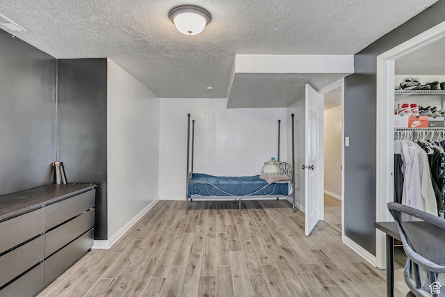 11645 S Keystone Dr, South Jordan, UT 84009 - bedroom featuring a textured ceiling, light wood finished floors, and a closet