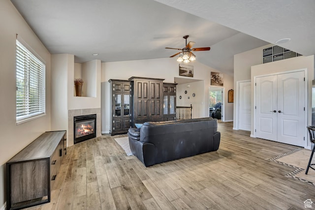 11645 S Keystone Dr, South Jordan, UT 84009 - living area featuring a ceiling fan, light wood-type flooring, a fireplace, and high vaulted ceiling