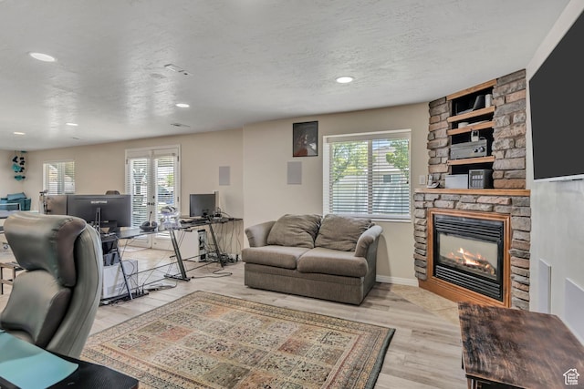 11645 S Keystone Dr, South Jordan, UT 84009 - living room with plenty of natural light, a fireplace, wood finished floors, recessed lighting, and a textured ceiling