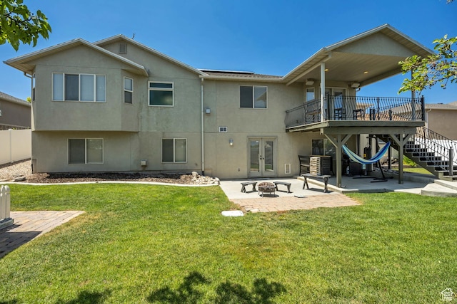 11645 S Keystone Dr, South Jordan, UT 84009 - back of house with french doors, a patio area, a fire pit, and stucco siding