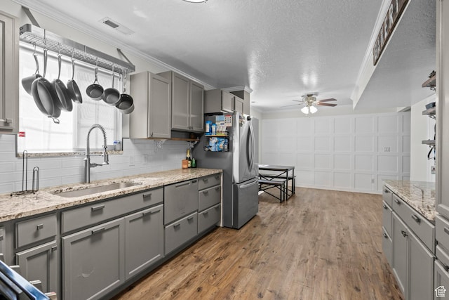 632 W 100 N, Spanish Fork, UT 84660 - kitchen with gray cabinetry, ceiling fan, freestanding refrigerator, wood finished floors, and a textured ceiling