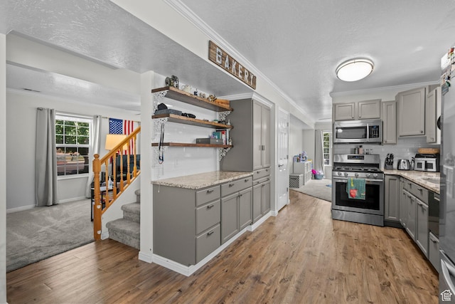 632 W 100 N, Spanish Fork, UT 84660 - kitchen with gray cabinetry, stainless steel appliances, backsplash, wood finished floors, and a textured ceiling