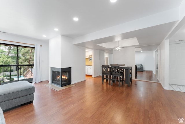 5544 S Springtree Ln E Unit H, Salt Lake City, UT 84107 - living room featuring wood finished floors, recessed lighting, and a multi sided fireplace