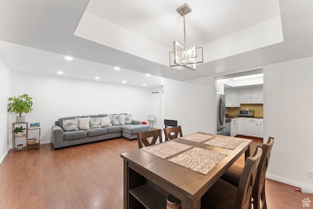 5544 S Springtree Ln E Unit H, Salt Lake City, UT 84107 - dining space featuring recessed lighting, wood finished floors, and a chandelier