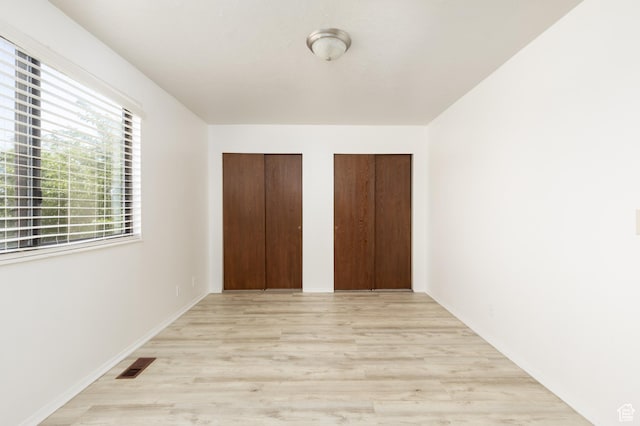 3453 W 5700 S, Taylorsville, UT 84129 - unfurnished bedroom with multiple closets and light wood finished floors