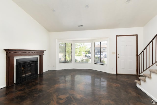 3453 W 5700 S, Taylorsville, UT 84129 - unfurnished living room with stairs, finished concrete flooring, and a fireplace