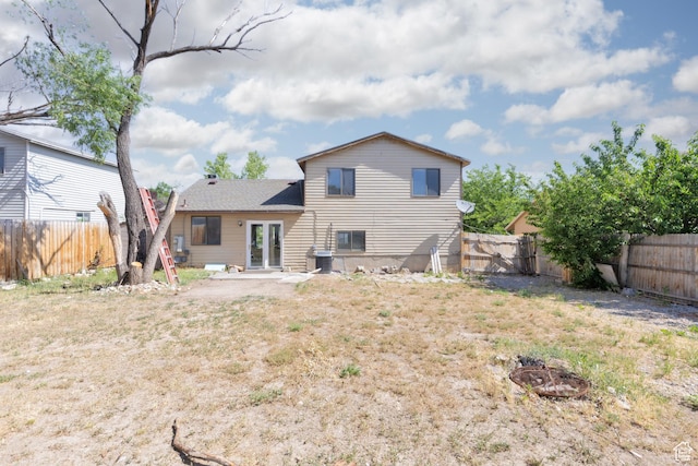 3453 W 5700 S, Taylorsville, UT 84129 - rear view of property featuring french doors, a fire pit, and a fenced backyard
