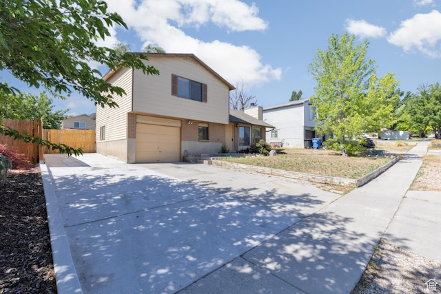 3453 W 5700 S, Taylorsville, UT 84129 - view of front of property featuring brick siding, concrete driveway, and an attached garage