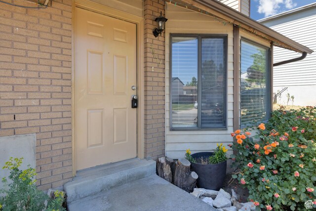 3453 W 5700 S, Taylorsville, UT 84129 - doorway to property featuring brick siding
