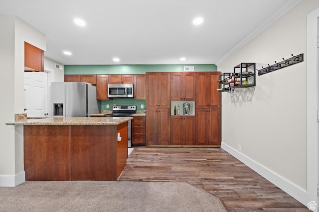 2095 S Main E Unit 5, Bountiful, UT 84010 - kitchen featuring stainless steel appliances, ornamental molding, brown cabinets, recessed lighting, and a peninsula