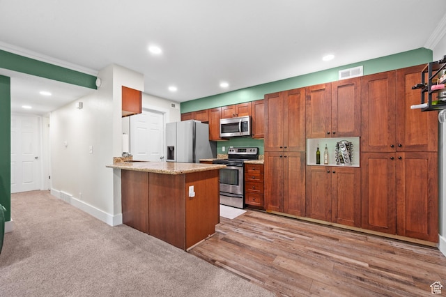 2095 S Main E Unit 5, Bountiful, UT 84010 - kitchen featuring stainless steel appliances, a peninsula, recessed lighting, brown cabinets, and light stone countertops