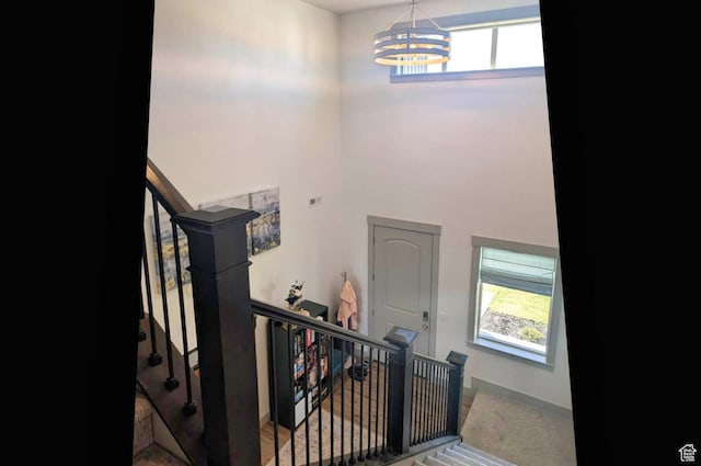 1991 Redtail Cir, Wellsville, UT 84339 - stairs featuring a chandelier, plenty of natural light, and a towering ceiling