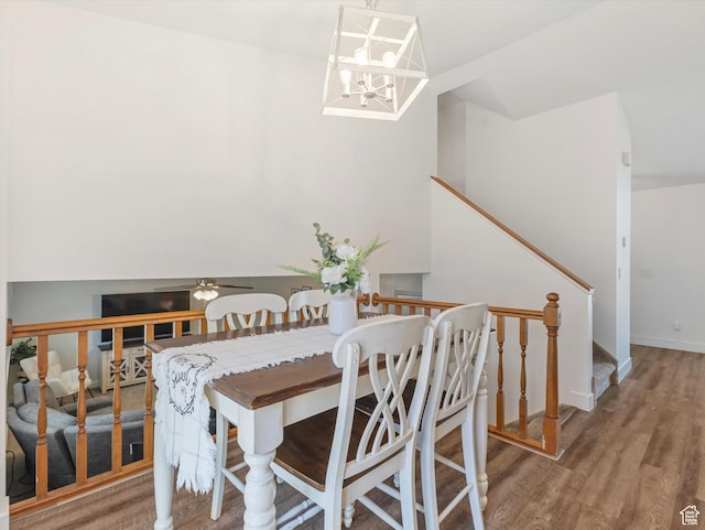 4736 S 2675 W, Roy, UT 84067 - dining area featuring wood finished floors, stairway, and a chandelier