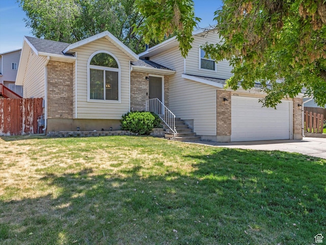 4736 S 2675 W, Roy, UT 84067 - tri-level home with driveway, brick siding, and an attached garage