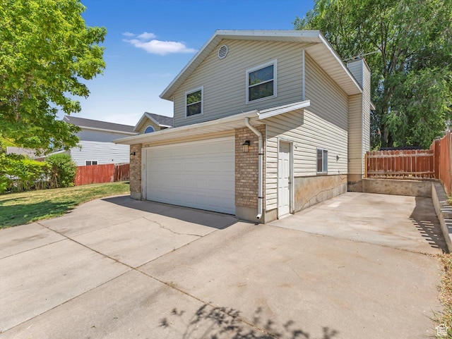 4736 S 2675 W, Roy, UT 84067 - view of front of property with a garage, concrete driveway, and brick siding