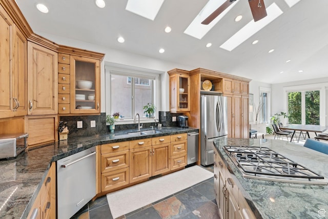 3231 E Lantern Hill Ct S, Cottonwood Heights, UT 84093 - kitchen with appliances with stainless steel finishes, a skylight, decorative backsplash, recessed lighting, and glass insert cabinets