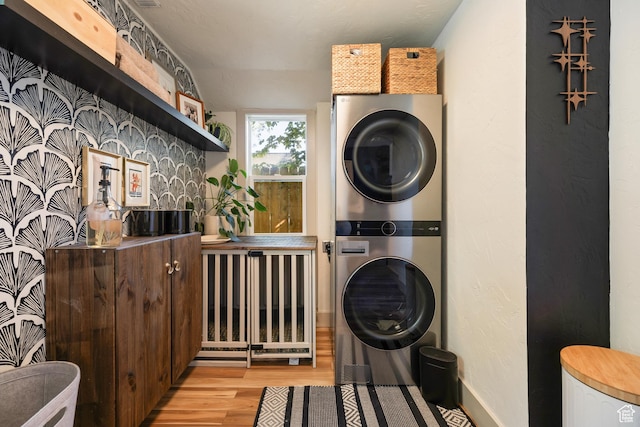 922 S 400 E, Salt Lake City, UT 84111 - laundry area featuring stacked washing machine and dryer and light wood finished floors