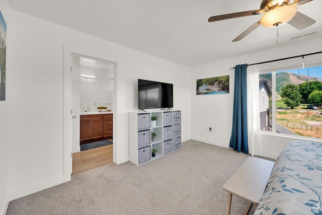 672 E 730 N Unit 25, Hyrum, UT 84319 - bedroom with light colored carpet, ensuite bath, and a ceiling fan