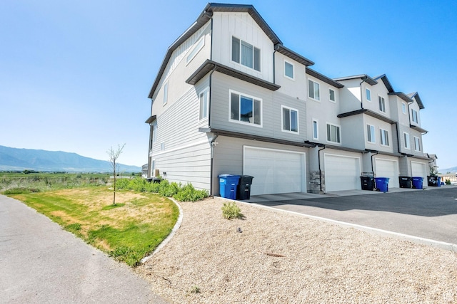 672 E 730 N Unit 25, Hyrum, UT 84319 - view of home's exterior with an attached garage, a mountain view, and driveway