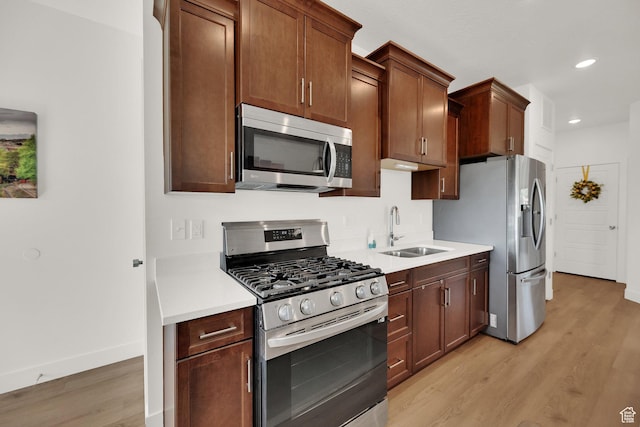 672 E 730 N Unit 25, Hyrum, UT 84319 - kitchen featuring appliances with stainless steel finishes, light wood-style floors, light countertops, and recessed lighting