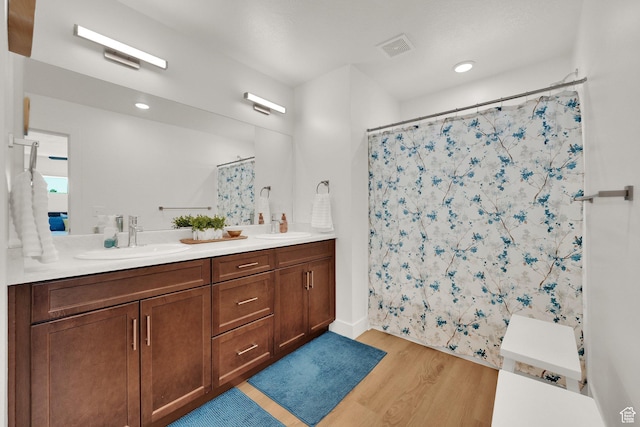 672 E 730 N Unit 25, Hyrum, UT 84319 - full bath with wood finished floors, double vanity, and a shower with shower curtain