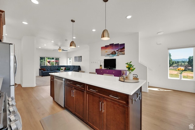 672 E 730 N Unit 25, Hyrum, UT 84319 - kitchen with open floor plan, light wood-type flooring, recessed lighting, hanging light fixtures, and stainless steel appliances