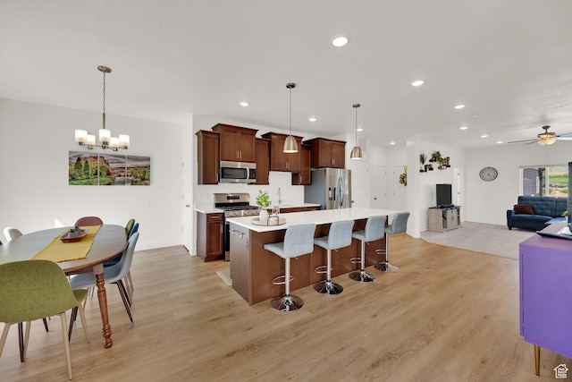 672 E 730 N Unit 25, Hyrum, UT 84319 - kitchen featuring stainless steel appliances, a chandelier, light countertops, a breakfast bar, and recessed lighting