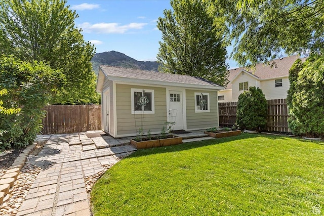 883 E 1775 N, North Ogden, UT 84414 - view of front of property featuring a mountain view, an outbuilding, a vegetable garden, and a patio