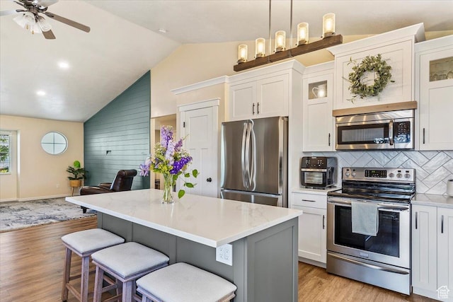 883 E 1775 N, North Ogden, UT 84414 - kitchen featuring stainless steel appliances, white cabinets, light wood-style flooring, a ceiling fan, and high vaulted ceiling
