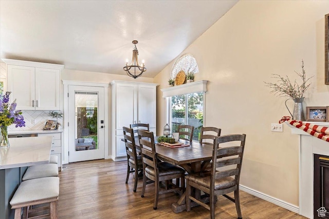 883 E 1775 N, North Ogden, UT 84414 - dining space with healthy amount of natural light, wood finished floors, a chandelier, and lofted ceiling