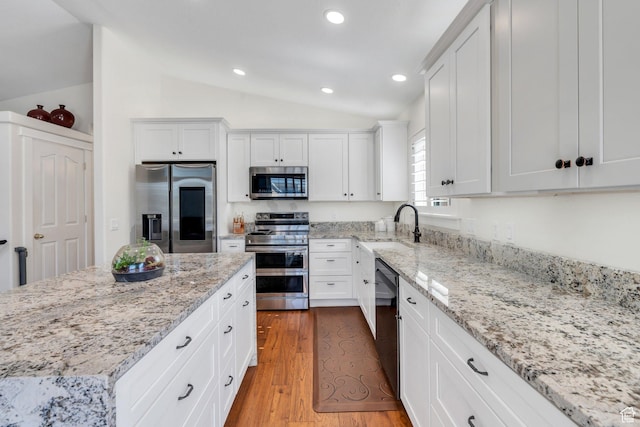 2541 S 1400 W, Woods Cross, UT 84087 - kitchen featuring stainless steel appliances, vaulted ceiling, white cabinets, recessed lighting, and light wood finished floors