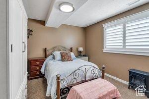 2541 S 1400 W, Woods Cross, UT 84087 - carpeted bedroom featuring a wood stove and baseboards