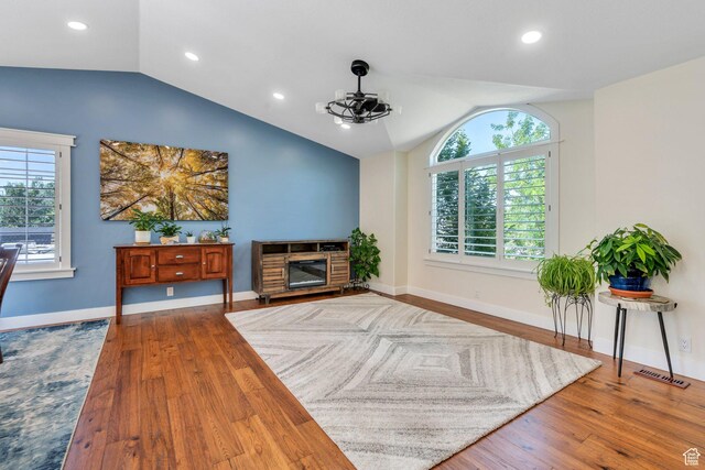 2541 S 1400 W, Woods Cross, UT 84087 - living room with lofted ceiling, healthy amount of natural light, wood finished floors, recessed lighting, and a glass covered fireplace