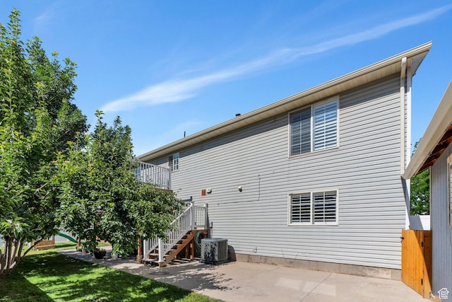 2541 S 1400 W, Woods Cross, UT 84087 - rear view of house featuring stairs, a patio, and a lawn
