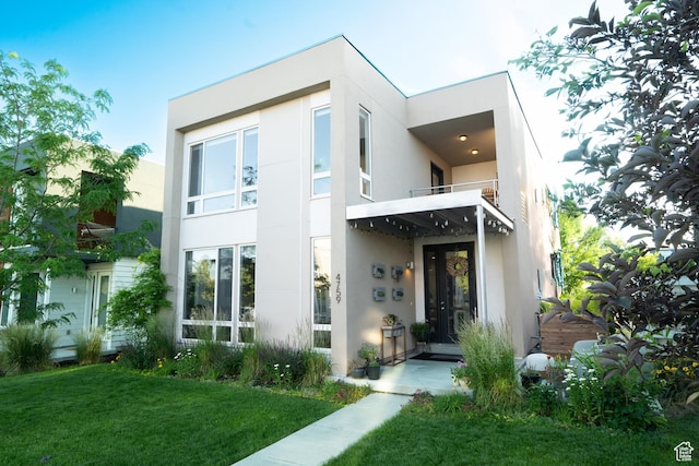 4759 W Vermillion Dr, South Jordan, UT 84009 - contemporary house with stucco siding, a balcony, and a front lawn