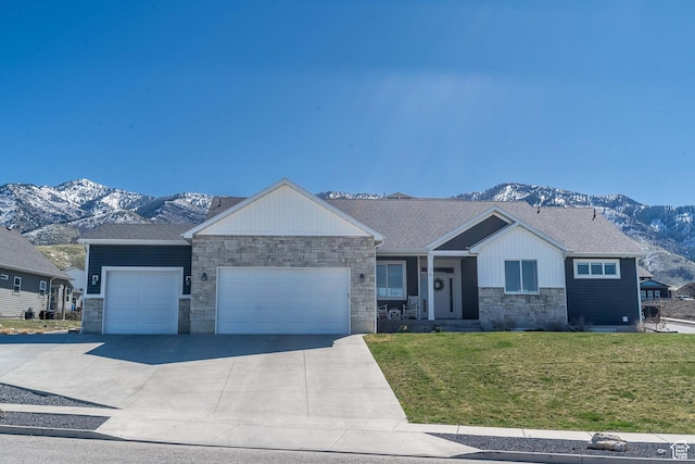 16 N 1000 E, Hyde Park, UT 84318 - ranch-style home featuring a mountain view, stone siding, a garage, a front lawn, and concrete driveway
