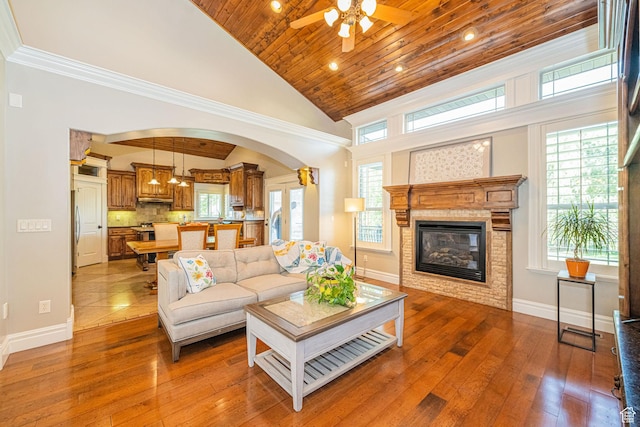 2989 W 2600 S, West Haven, UT 84401 - living room with ceiling fan, arched walkways, a glass covered fireplace, hardwood / wood-style floors, and wood ceiling