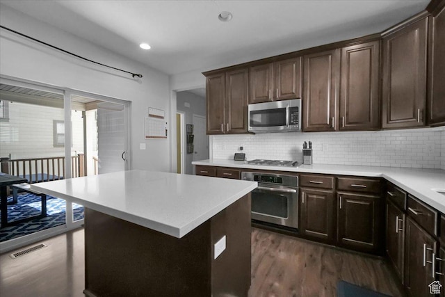 4439 W Mille Lacs Dr, South Jordan, UT 84009 - kitchen featuring stainless steel appliances, dark wood finished floors, light countertops, dark brown cabinets, and recessed lighting