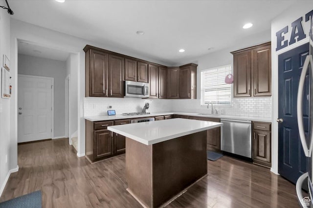 4439 W Mille Lacs Dr, South Jordan, UT 84009 - kitchen featuring stainless steel appliances, light countertops, dark wood-style floors, backsplash, and recessed lighting