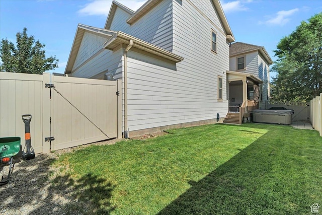 4439 W Mille Lacs Dr, South Jordan, UT 84009 - view of side of property with a gate, a hot tub, and a fenced backyard