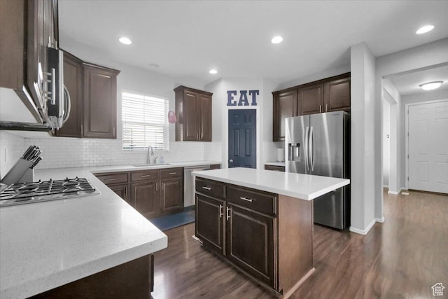 4439 W Mille Lacs Dr, South Jordan, UT 84009 - kitchen featuring stainless steel appliances, light countertops, backsplash, dark brown cabinetry, and recessed lighting