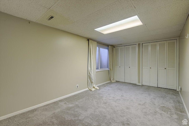 4879 S 1690 E, Holladay, UT 84117 - unfurnished bedroom with multiple closets, carpet floors, and a drop ceiling