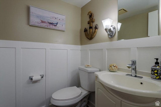4879 S 1690 E, Holladay, UT 84117 - bathroom featuring a decorative wall, vanity, and wainscoting
