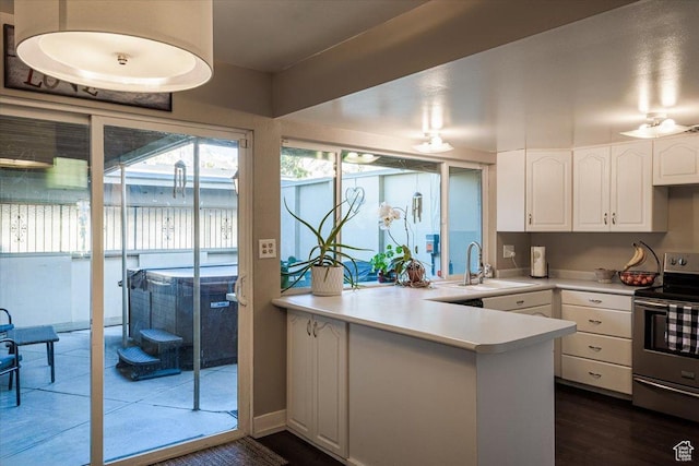 4879 S 1690 E, Holladay, UT 84117 - kitchen featuring electric stove, white cabinets, a peninsula, and light countertops